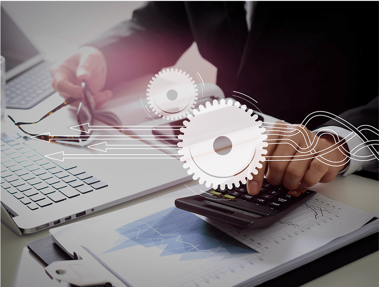 A person using a calculator on top of a desk.