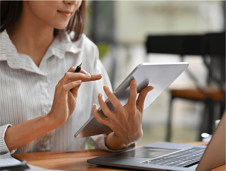 A woman is using her tablet at the table