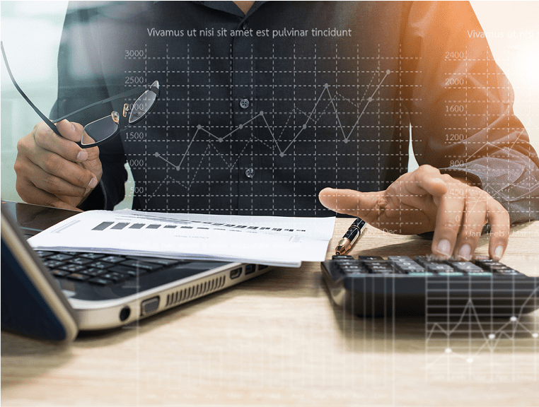 A person is working on some papers and a calculator